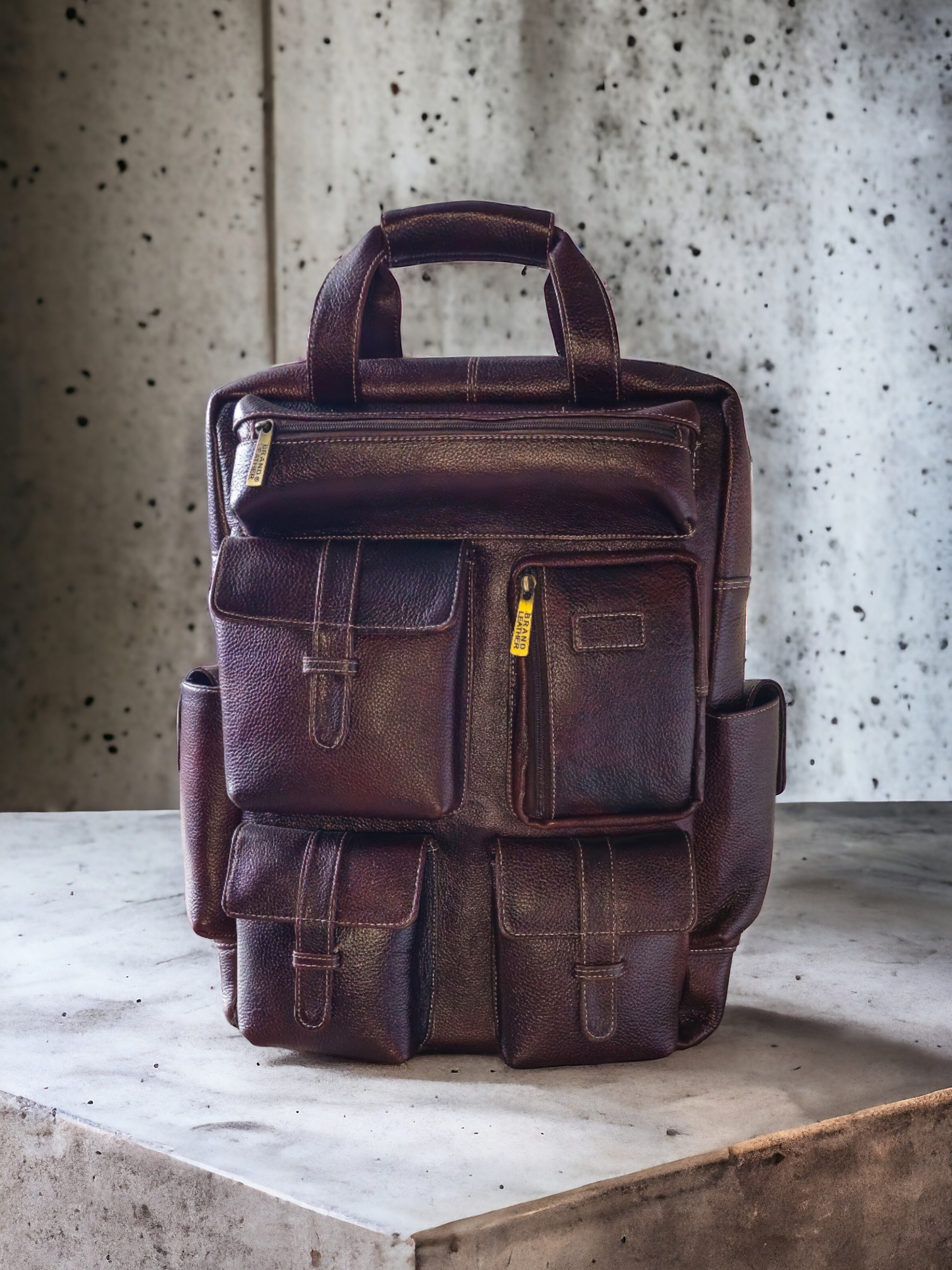 Brown leather unisex backpack with spacious compartments, side pockets, and secure zipper closures. Durable, stylish, and perfect for work, school, or travel.